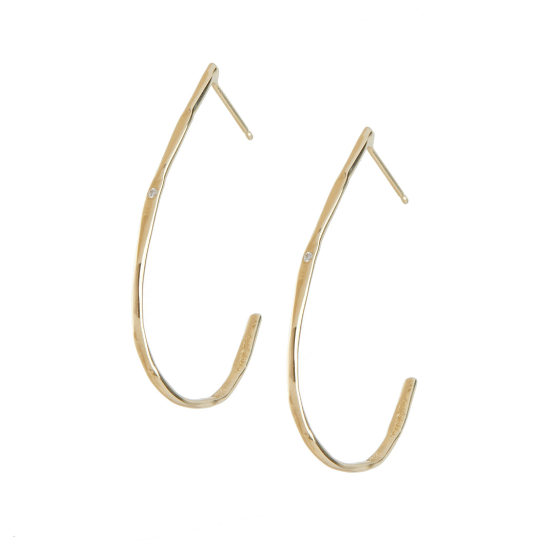 These are the perfect gold hoop staple earrings. The diamonds provide an unexpected touch of sparkle to each earring. 14K Yellow Gold  Diamonds are set on both hoop earrings Organic shaped hoop earrings Post back Handcrafted in NYC