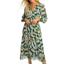 Load image into Gallery viewer, The Stace Maxi Dress features a vibrant desert mosaic print in blue, green, and light pink hues, evoking a springtime aesthetic. Made from 100% Viscose, the dress has a lightweight, flowing silhouette that drapes elegantly to maxi length. Long sleeves add sophistication, making it a perfect blend of comfort and style for both daytime and evening events.
