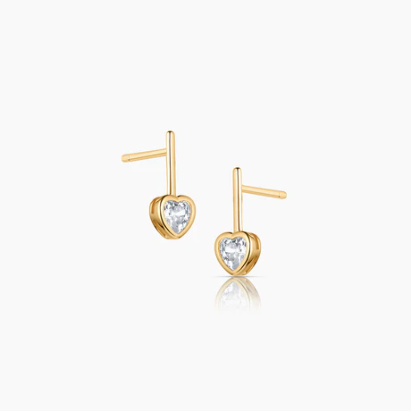 Elevate your jewelry collection with Thatch's stunning 14k gold plated heart-shaped drop earrings. Featuring a 5mm clear cubic zirconia in a dazzling heart shape, these earrings offer a timeless and elegant look that adds the perfect touch of sparkle to any outfit. The drop design measures 13.5mm in length and 2.5mm in thickness, making them a refined yet eye-catching accessory. With a secure post backing, these earrings are both comfortable and stylish, perfect for everyday wear or special occasions. Treat