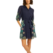 Load image into Gallery viewer, The Eloise Dress in our&nbsp; Geo Bloom print is a must-have for spring. This shirt dress is adorned with delicate geometric floral clusters along the sleeves and sides of the skirt, adding a playful yet sophisticated touch.

Designed for effortless elegance, the Eloise features a self-tie at the waist to flatter your silhouette and a hidden placket running the length of the dress for a seamless, polished finish. Perfect for any occasion, this dress pairs beautifully with sandals or heels for a fresh and ve
