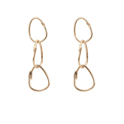These earrings are a celebration of fluid design. The combination of the drops' lengths and the intricacies of their design adds depth and intrigue to the earrings, making them a statement of individuality and taste.  14K recycled rose gold 3 interlocked gold rings  Post back  Handcrafted in NYC 